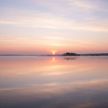Pastel dawn sky over calm water