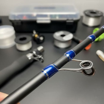 Graphite rod blank closeup with guides